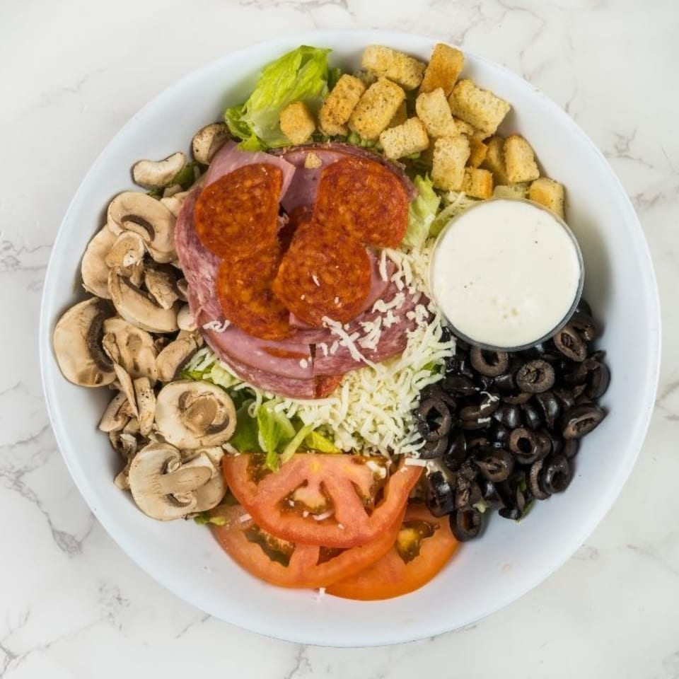 A South Lake Pizza antipasto salad with pepperoni, ham, mushrooms, olives, tomatoes, and croutons.